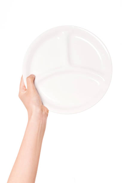 istock woman hand holding a ceramic dish isolated on white. 1265499290