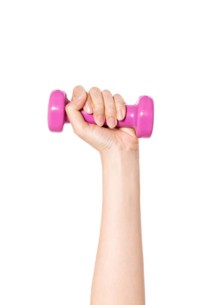 istock woman hand holding a pink dumbbell isolated on white. 1265499839