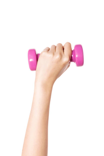 istock woman hand holding a pink dumbbell backside isolated on white. 1265500639