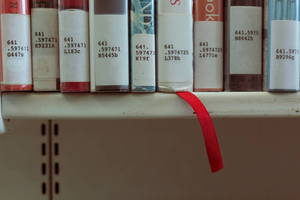 istock Close up of books on shelf red bookmark 1265501155