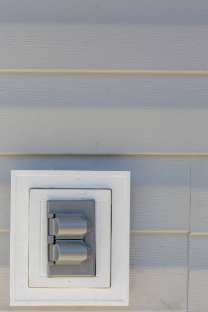 istock Electrical outlet on outside house siding 1265501157