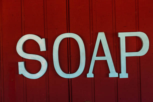 istock Cut out lettering spelling soap on barn siding 1265501257