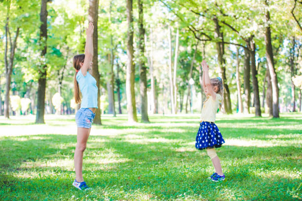 istock Girls warming-up in park 1265503331
