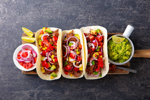 istock Taco with meat and vegetables on cutting board. Grey background. Top view. 1265504401