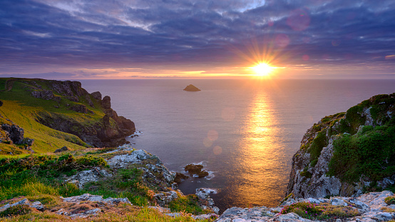 Pentire, UK - July 17, 2020:  Summer sunset over Pentire Head and The Rumps, North Cornwall near Padstow, UK