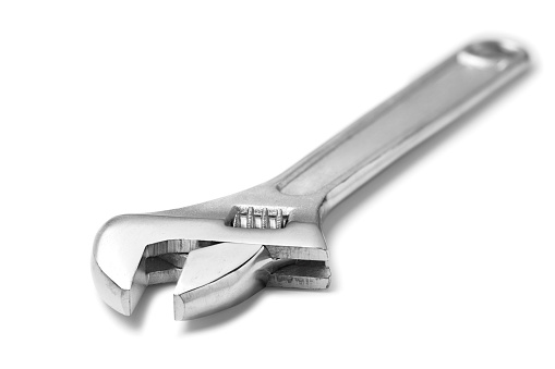 Adjustable spanner isolated on white.\n\nChrome vanadium wrench. Industrial spanner.