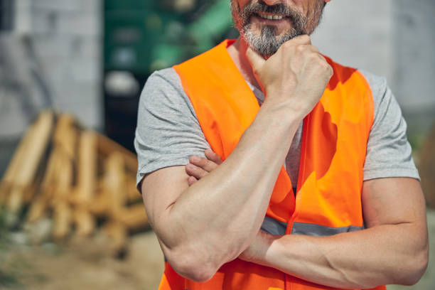 istock Pleased builder in a reflective vest standing outside 1265517888
