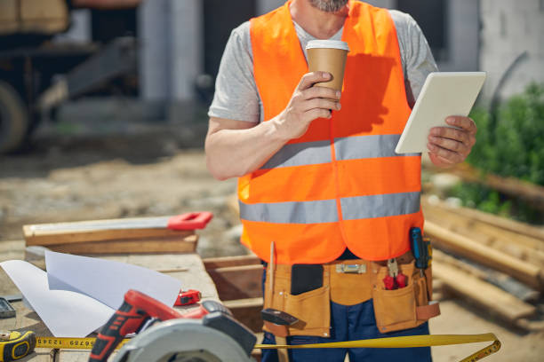 istock Builder with a paper cup of coffee 1265517901