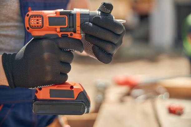istock Male hands holding a cordless screw gun 1265517974