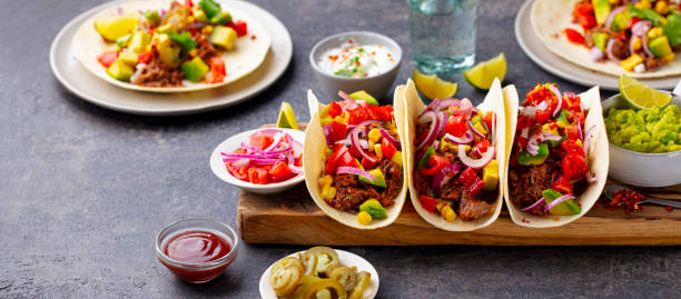 istock Taco with meat and vegetables on cutting board. Grey background. Close up. 1265531187