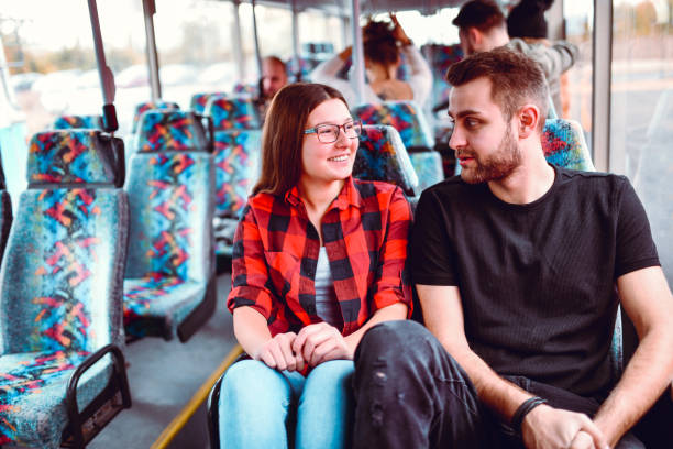 istock Couple Smiling And Enjoying Good Conversation While Traveling By Bus 1265543049