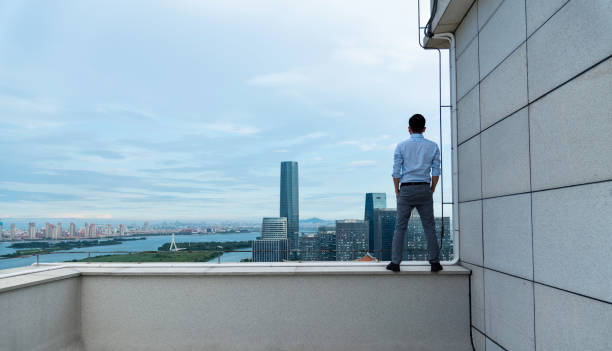 istock Businessman looking at cityscape on the rooftop 1265543652