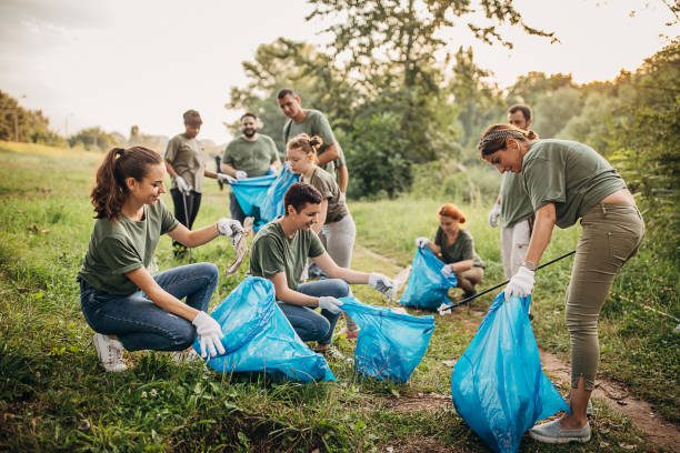 istock Group of volunteers cleaning nature together 1265544421