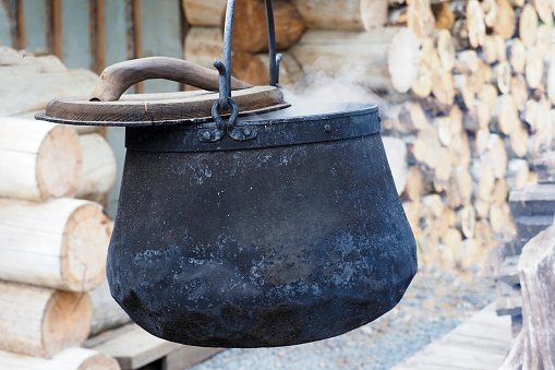 Smoked cauldron on open fire, brewing a potion