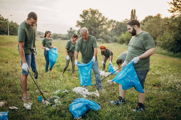istock Group of people collecting garbage from nature 1265545161