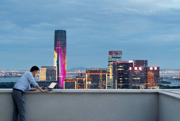 istock Businessman standing on the rooftop and using laptop 1265546048