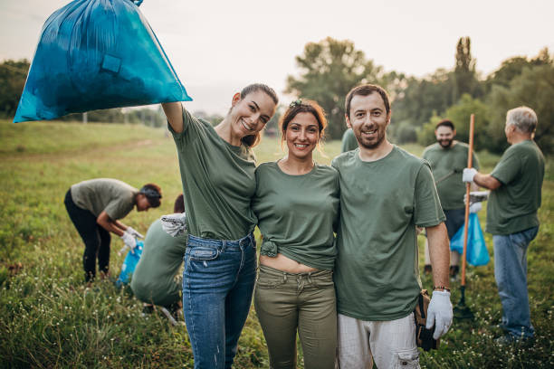 istock Happy three environmental volunteers in public park 1265546223