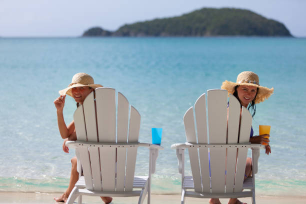 istock attractive women in having fun in Adirondack chairs on a tropical beach 1265546285