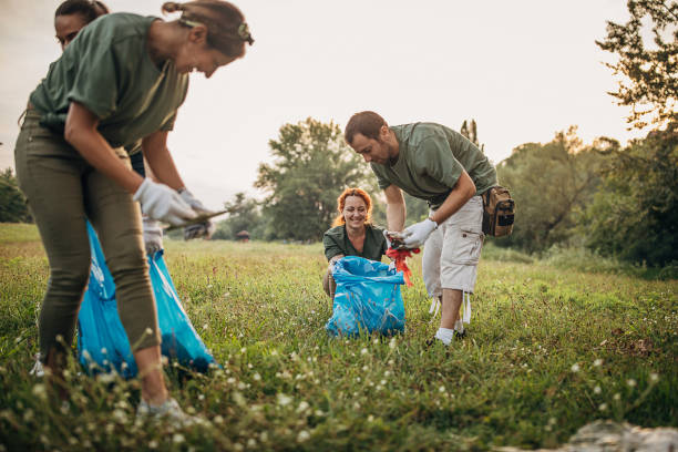 istock Happy volunteers collecting garbage from the public park 1265546436
