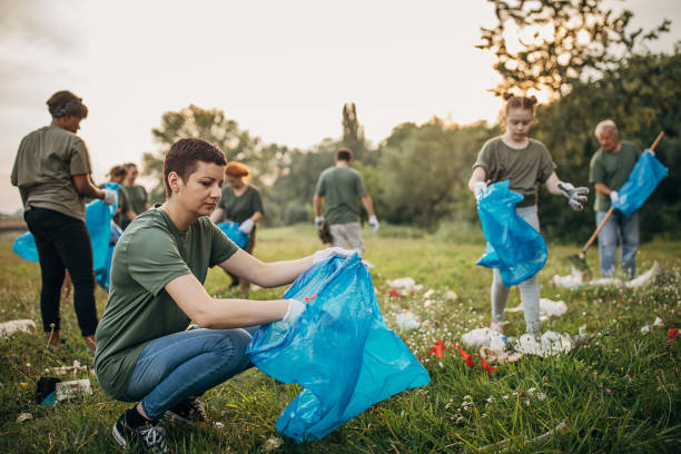 istock Multi-ethnic group of people collecting garbage from the public park 1265546713