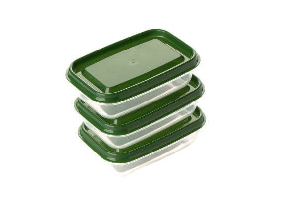 istock Three clear plastic food containers with green lids. 1265546870
