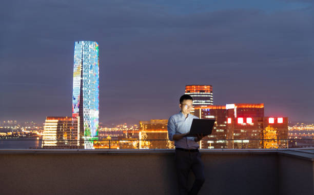 istock Businessman standing on the rooftop and using laptop 1265546954