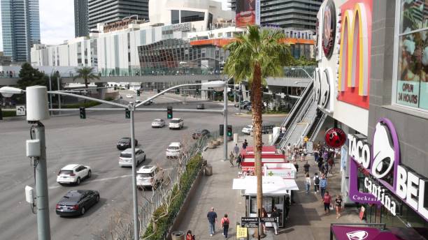 the strip boulevard with luxury casino and hotels in gambling sin city. car traffic on road to fremont street in tourist money playing resort. people and mcdonalds - downtown las vegas fremont street experience nevada las vegas metropolitan area imagens e fotografias de stock