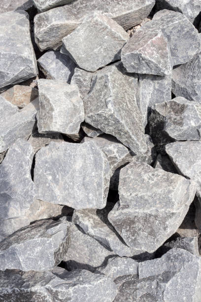 istock Black and gray rough large stone granite background. 1265548244