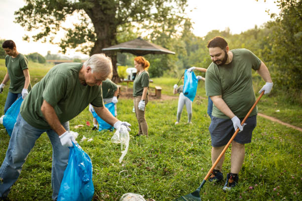 istock Volunteers team cleaning public park together 1265548616
