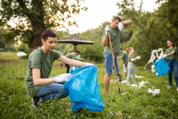 istock Volunteers picking up garbage while cleaning public park 1265548663