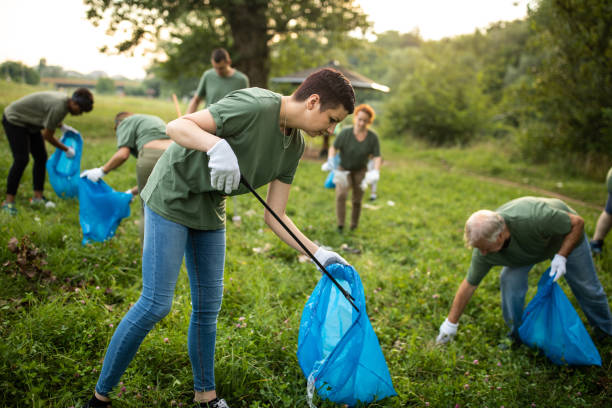 istock Volunteers cleaning environment together 1265548723