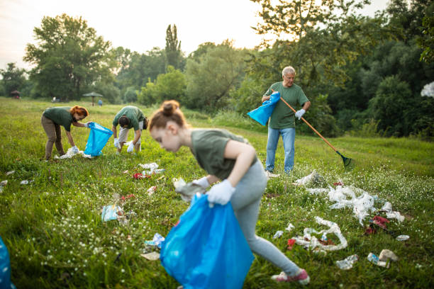 istock Group of volunteers picking up garbage while cleaning public park 1265549361