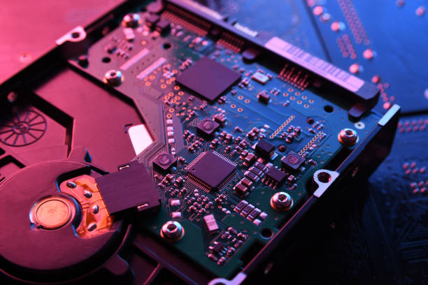 istock Computer Hard disk drives HDD , SSD on circuit board ,motherboard background. Close-up. With red-blue lighting 1265549370