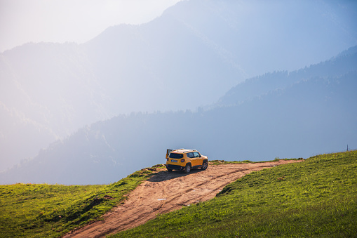 A Yellow Jeep Renegade SUV car on mountain road of Pokut Plateau, Camlıhemsin, Rize, Turkey