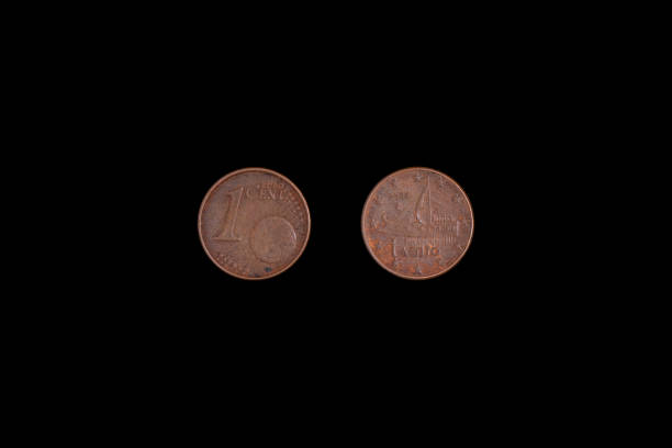 istock 1 euro cent coin issued in Greece, on a black background. Close-up on both sides 1265552199