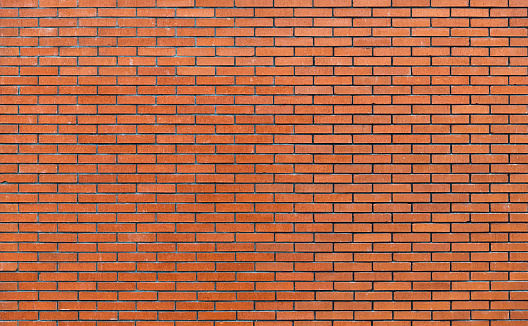 An abstract image or background of a building exterior made of red bricks