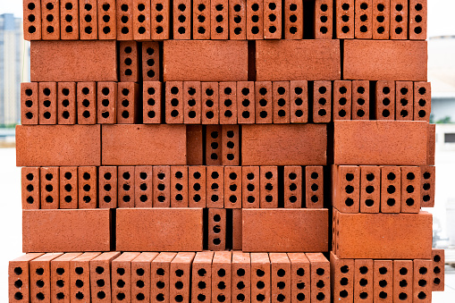 Blocks of building tiles of gray color are on the street. Theme of building construction