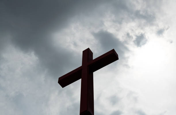 istock Religious cross under the cloudy sky 1265555084