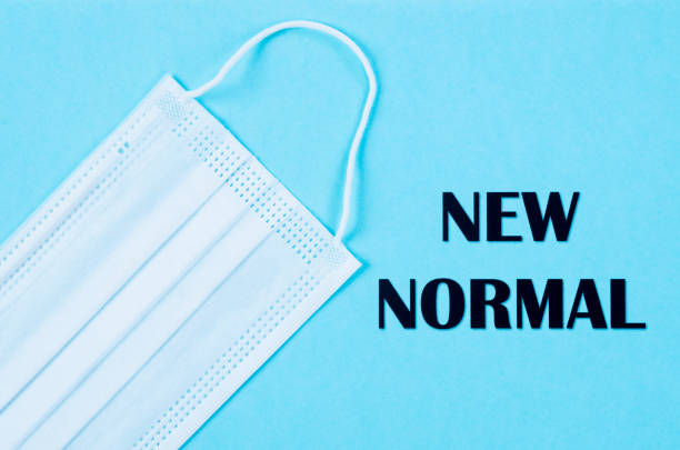 istock NEW NORMAL word with surgical medical face mask. 1265555241