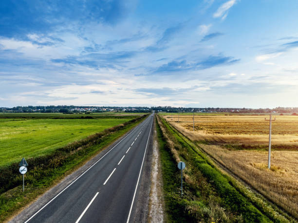 istock Road through agricultural field. Aerial shot 1265557169