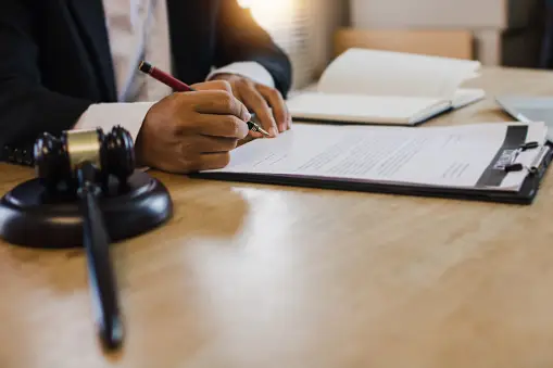 probate in texas, hand of business people sign contract with justice hummer on table