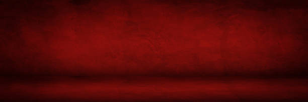 istock dark red cement texture background and studio room for show products 1265565614