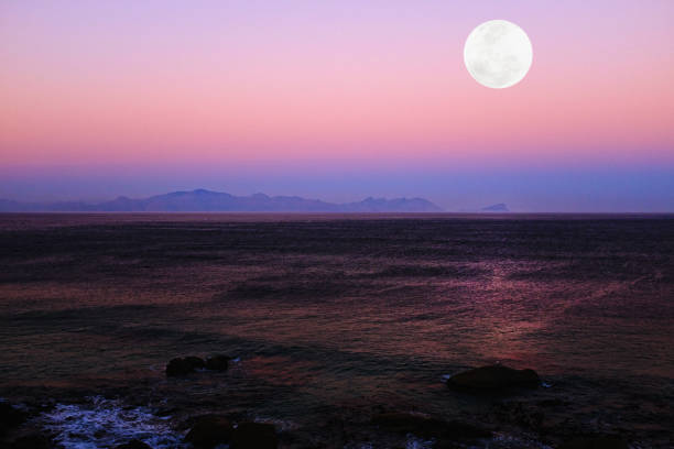 Idyllic moonrise over a tranquil ocean.