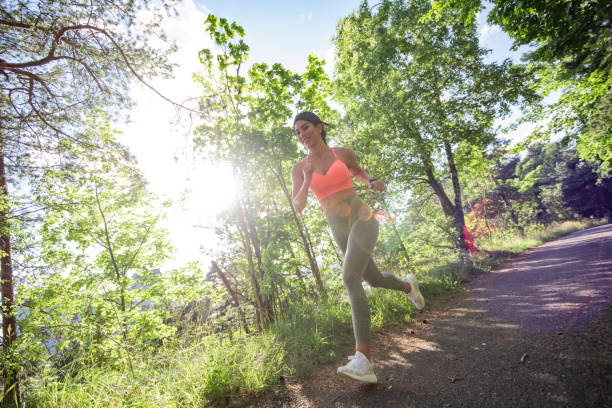 istock Fit woman running at park. 1265568395