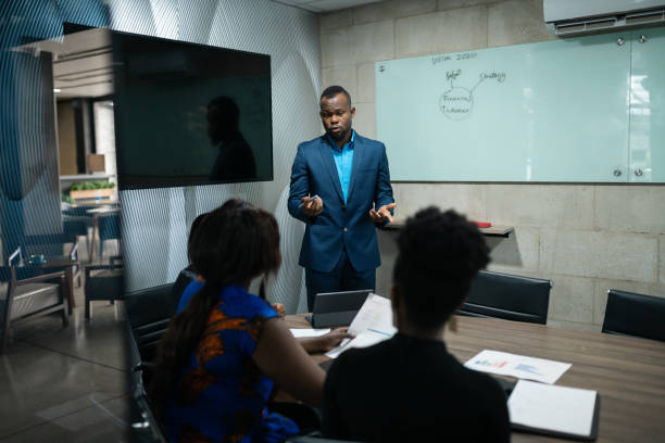 istock North African businessman giving a whiteboard presentation to office c 1265568493