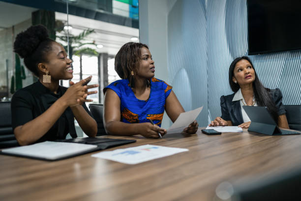 istock Businesswomen sitting around a table during a boardroom presentation 1265568494