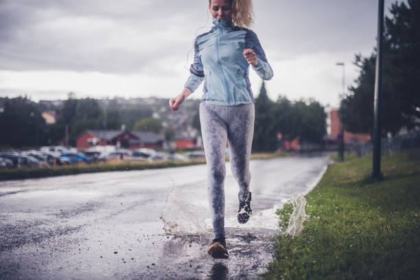 istock Athlete running at the rain. 1265573090