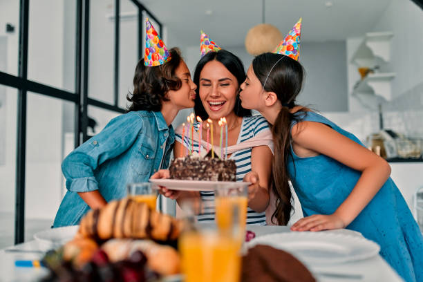 Family at home Happy Birthday! Beautiful mother and handsome father with their daughter and son spending time together at home and celebrating Birthday. Happy family concept. birthday wishes for daughter stock pictures, royalty-free photos & images