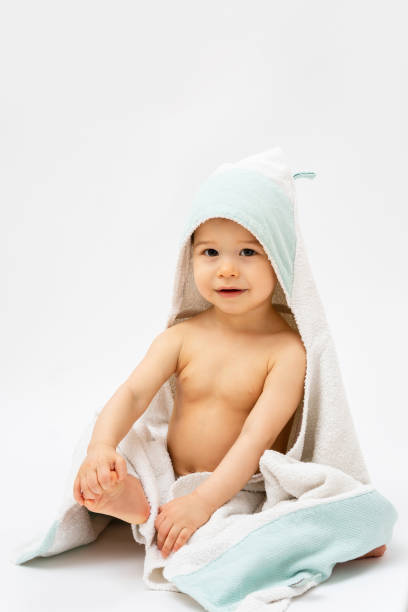 istock Cute baby wrapped into hooded towel after a bathing 1265581459