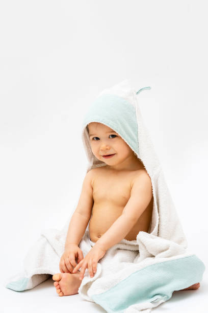 istock Cute baby wrapped into hooded towel after a bathing 1265582031